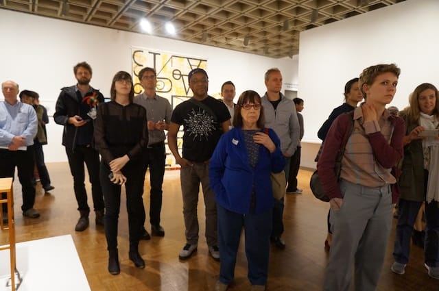 Bystanders listening to the cliterati's utopian vision