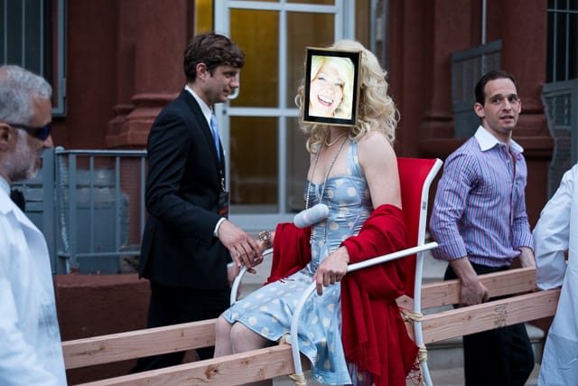 Performance Artist Clarina Bezzola leads the cavalcade of guests from Whitebox Art Center to The Box.