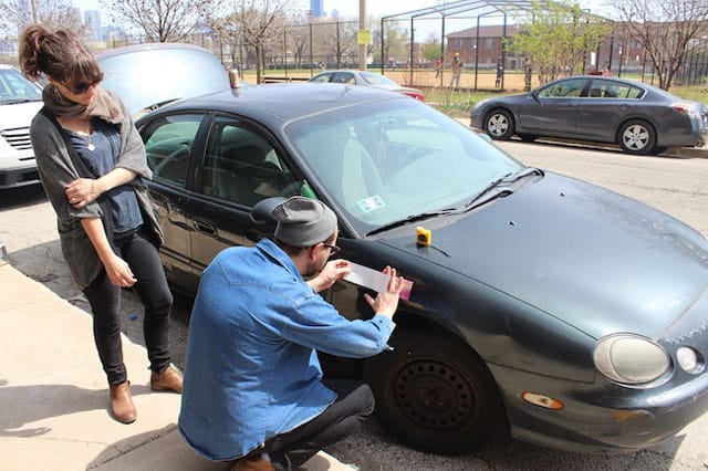 Jesse Malmed begins the ritualistic affixing of Laura Hart Newlon's sticker for Trunk Show's April show