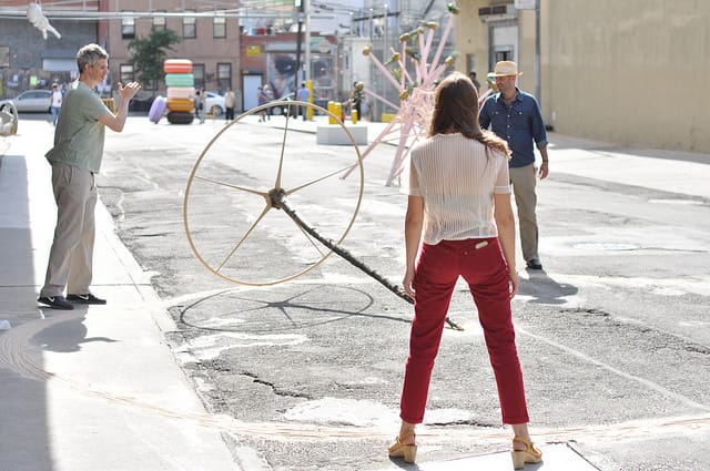 Visitors playing with a sculpture that was part of REAL on Rock Street.