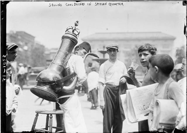 A Syrian man selling cold drinks in the Syrian quarter (image via Library of Congress/Wikipedia)