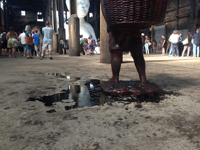 Molasses pools beneath one of the statues