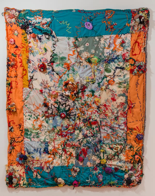 Marie Roseman, "Untitled (Throw)" (c. late 1960s), yarn, sequins, thread, fabric, plastic beads, lame, pin cushion on quilt, 50 x 60 in (collection of Donald Roseman) (photo by Adam Reich, courtesy Studio Museum)