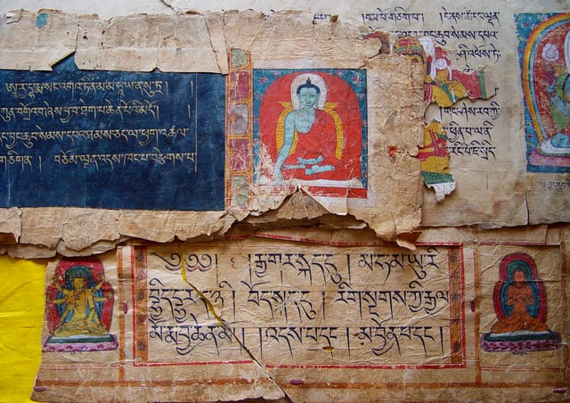 Scattered fragments of rare twelfth-century illuminated Tibetan texts from Keu Lhakang Temple, Central Tibet – before being digitised, restored and re-ordered. Photograph by Psang Wangdu, 2002