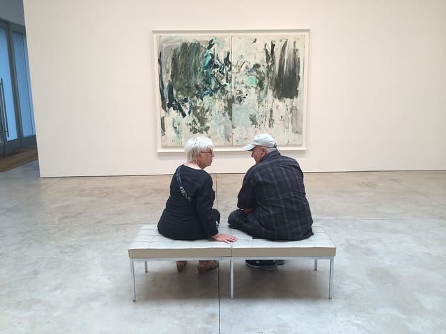A couple discusses a Joan Mitchell Tree painting at Cheim & Read gallery (photo by the author for Hyperallergic)