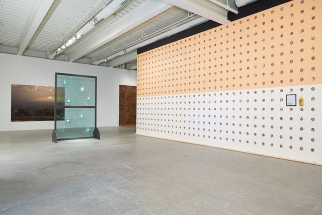 Installation view, 'Ruffneck Constructivists,' with Kendell Geers's "Stripped Bare" (2000) in middle and William Pope.L's "Claim" on right (click to enlarge)