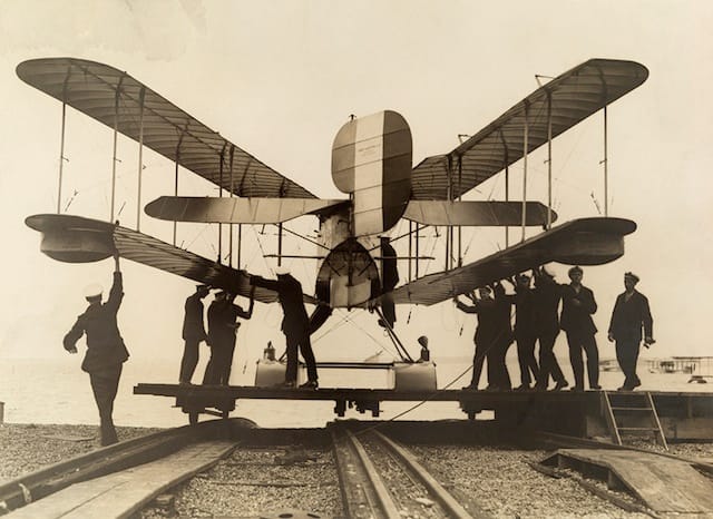 Inspecting a British airplane with folding wings (1918) (via National Geographic Found)
