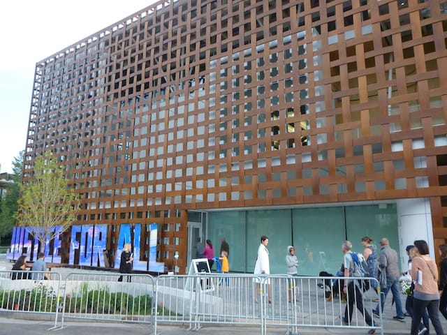 The exterior of the Aspen Art Museum, designed by Shigeru Ban. A slice of John Hodges's With Liberty and Justice For All (A Work in Progress) can be seen below. All images by the author for Hyperallergic.