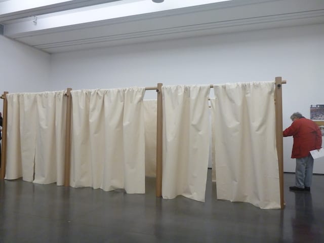 A visitor checks out Ban's Paper Partition System, set up after the Great Japan Earthquake and the 2011 tsunami.
