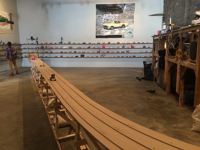 A view of Peirogi Boiler with all the gravity racers lined up against the wall and the track in the middle. (all photos by the author for Hyperallergic)