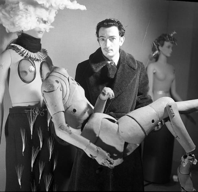 A photograph by Denise Bellon, taken at the International Exhibition of Surrealism, shows Salvador with the lay figure he used as the chauffeur in "Le Taxi Pluvieux" (1938). (Image courtesy of Fonds Photographique Denise Bellon, Paris © Les Films de l’Équinoxe Fonds Photographique Denise Bellon © Salvador Dalí, Fundació Gala Salvador Dalí, DACS, 2014)