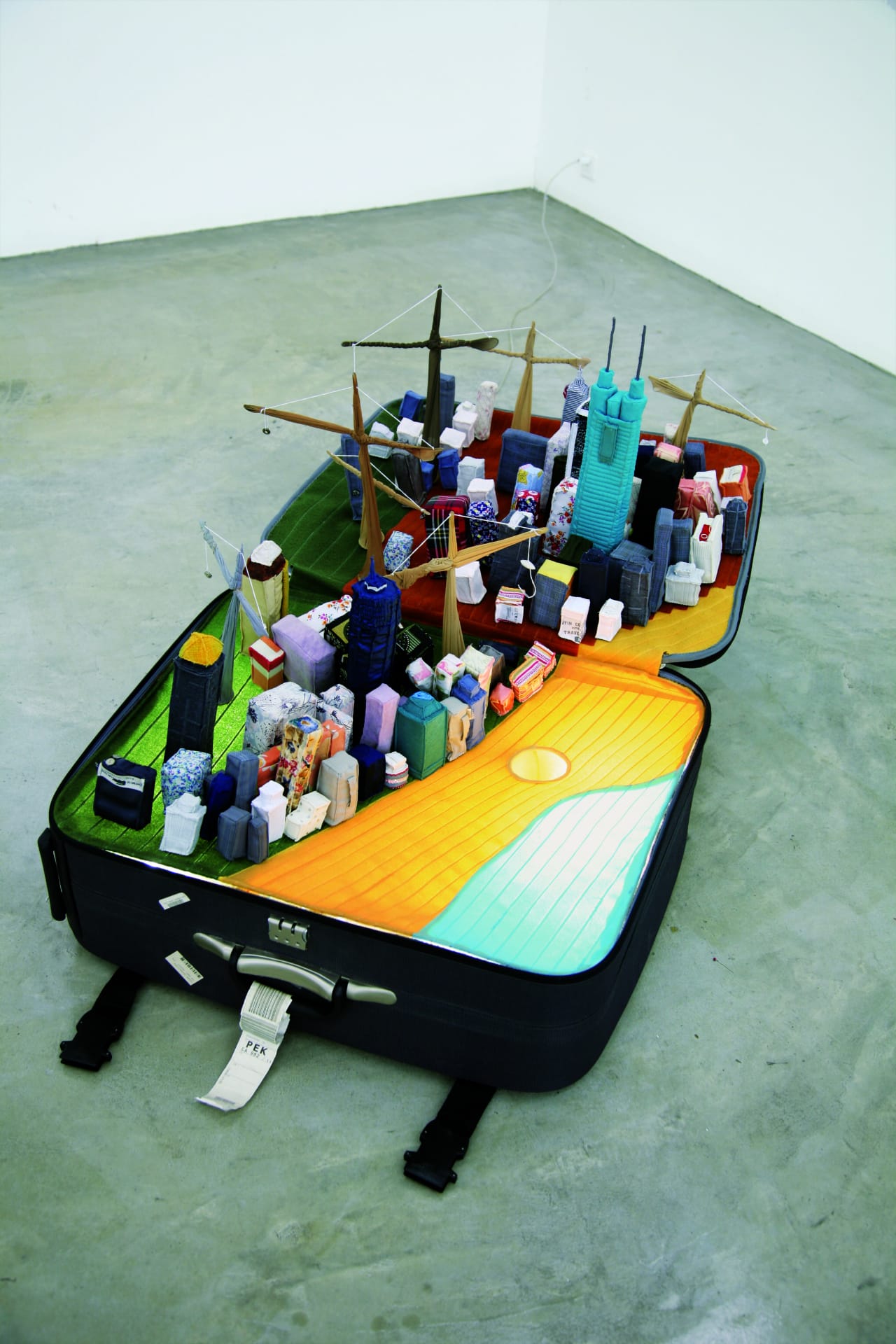 Yin Xiuzhen, Portable City: Shenzhen, 2008.Suitcase, found objects. Dimensions variable. Image credit: Courtesy of the Pace Gallery, Beijing. ©Yin Xiuzhen.