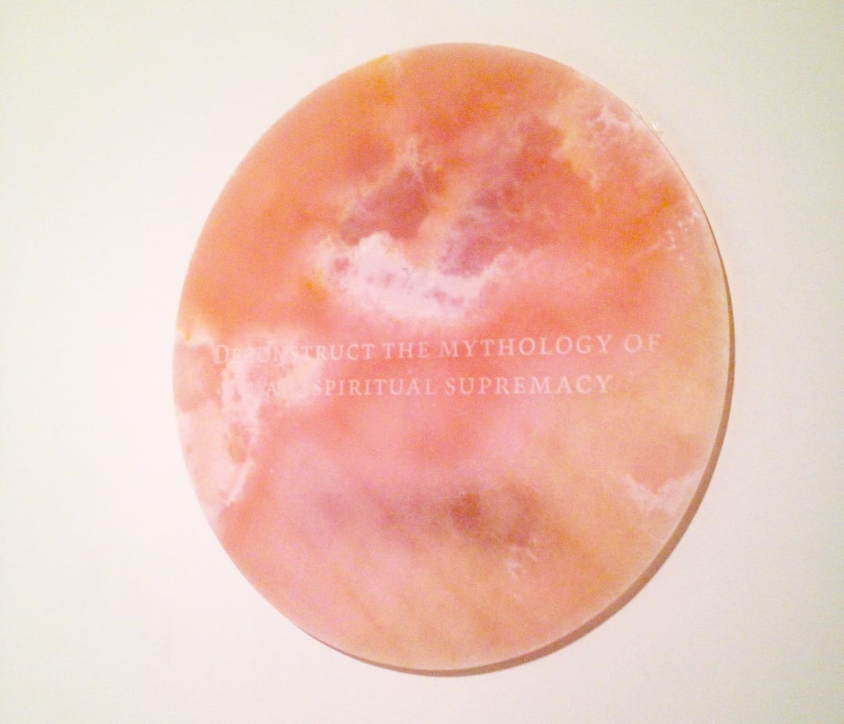 Installation view of Future Feminists' XI: DECONSTRUCT THE MYTHOLOGY OF MALE SPIRITUAL SUPREMACY, 2014, Rose Quartz 50 x 50 x .75 inches.