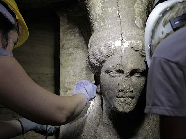 Archeologists handling one of the two newly discovered caryatids in Kasta Tumulus in Macedonia. (all images courtesy Greek Ministry of Culture)