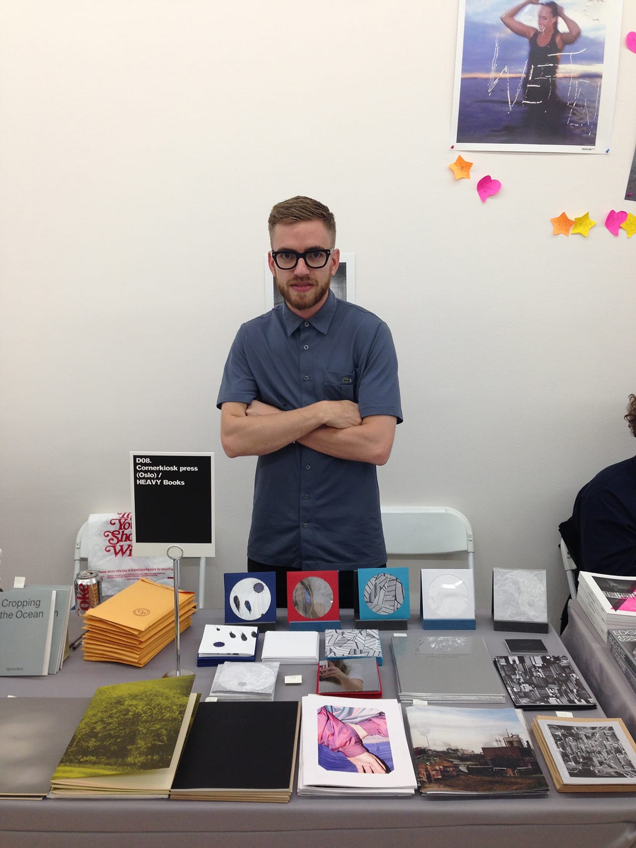 Chris Tunge (Heavy Books) in from of his shared stand with Cornerkiosk press.