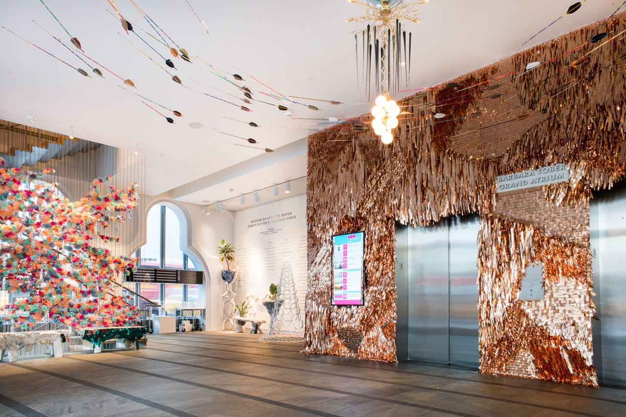 Installation view, ‘NYC Makers: The MAD Biennial’ at the Museum of Arts and Design, 2014, including detail of "Fringe Wall–Copper" (2014) and "Catalogue" 01 (2014) by CONFETTISYSTEM; two iterations of Pig Bench (2014), Heyerdahl Bench, and Heyerdahl Coat Rack/Planter/Lamp, (2014) all by Misha Kahn; "100 Arrows" (2014) by Fredericks & Mae; "Totem" II (2014) by Lindsey Adelman with Nancy Callan; and "X-Tower" 54.4 (2013) by MILGO/BUFKIN , fabricator and Haresh Lalvani, designer (photo by Eric Scott)