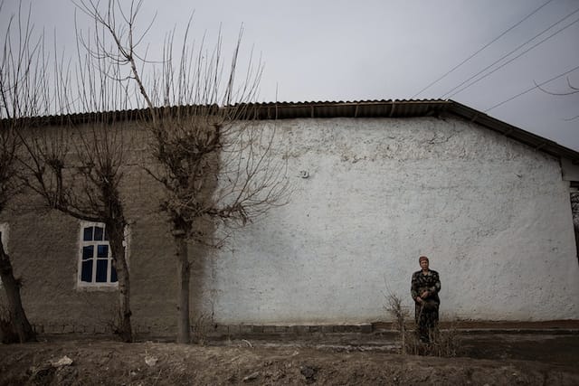 A Uzbek woman awaits her sons. She has no idea what city they are currently working in. 