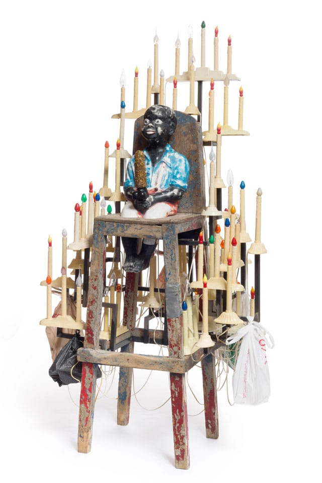 Nick Cave, "Golden Boy" (2014), mixed media including concrete garden ornament, vintage high chair, dildo, and holiday candles, 73 3/4 x 41 x 35 in (© Nick Cave) (photo by James Prinz Photography, courtesy the artist and Jack Shainman Gallery, New York) 