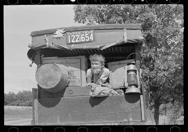 Child in a migrant car heading east near Fort Gibson, Oklahoma, photograph by Russell Lee (June 1939) (via Photogrammar/Library of Congress)