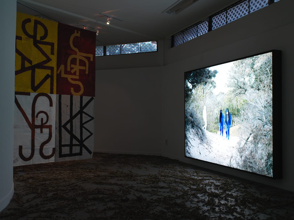 Left to right, one of eight sigil paintings by Elijah Burgher (2013-2014), “Blue” (2011) by Ryan Brewer and AA Bronson.