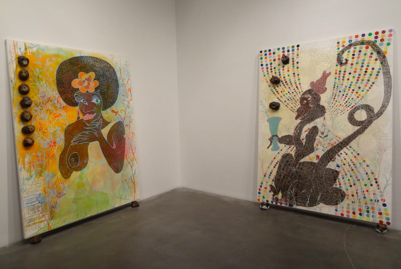 Installation view of 'Chris Ofili: Night and Day' with "Blossom" (1997, at left) and "Monkey Magic - Sex, Money and Drugs" (1999, at right)