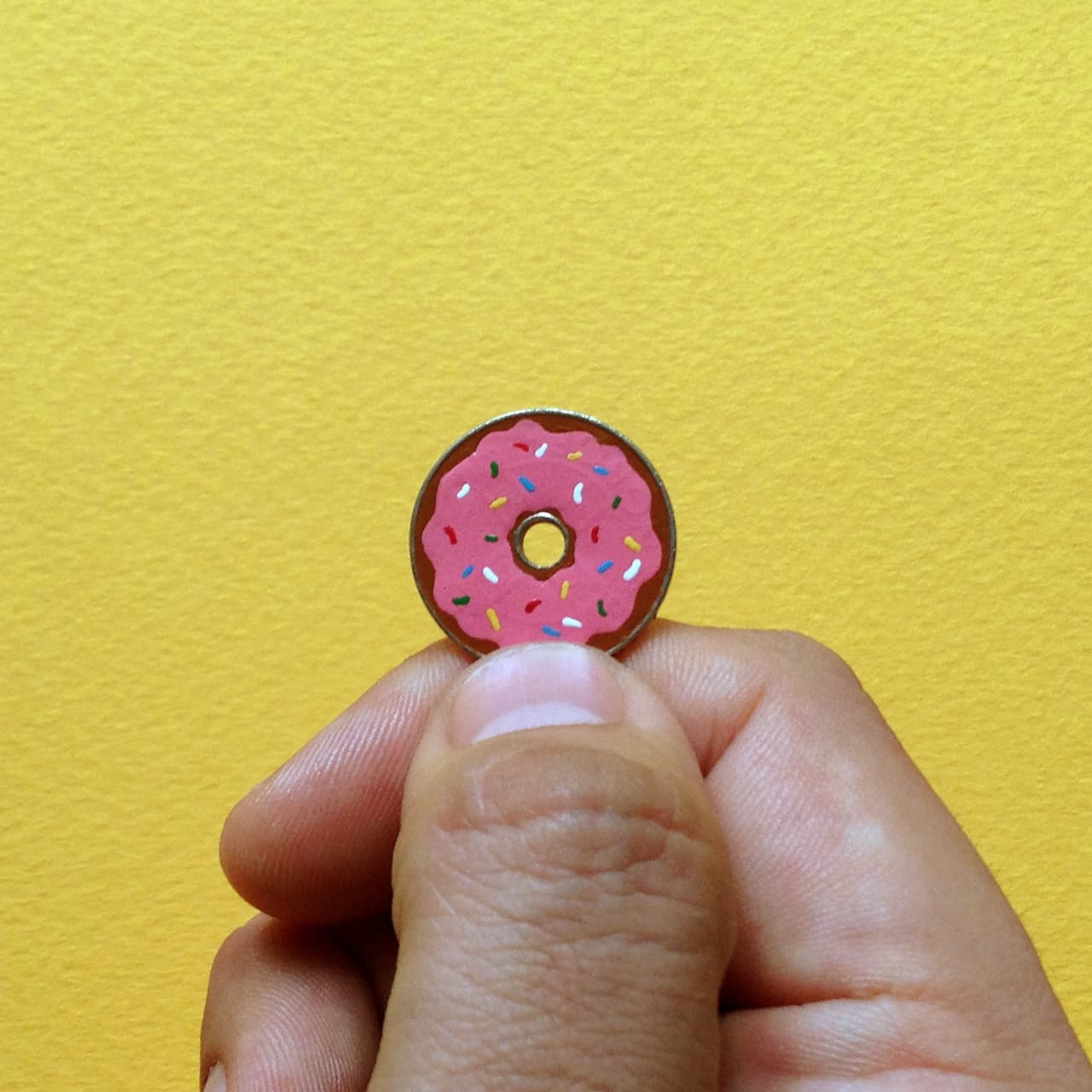Andre Levy coin painting of a Simpsons doughnut