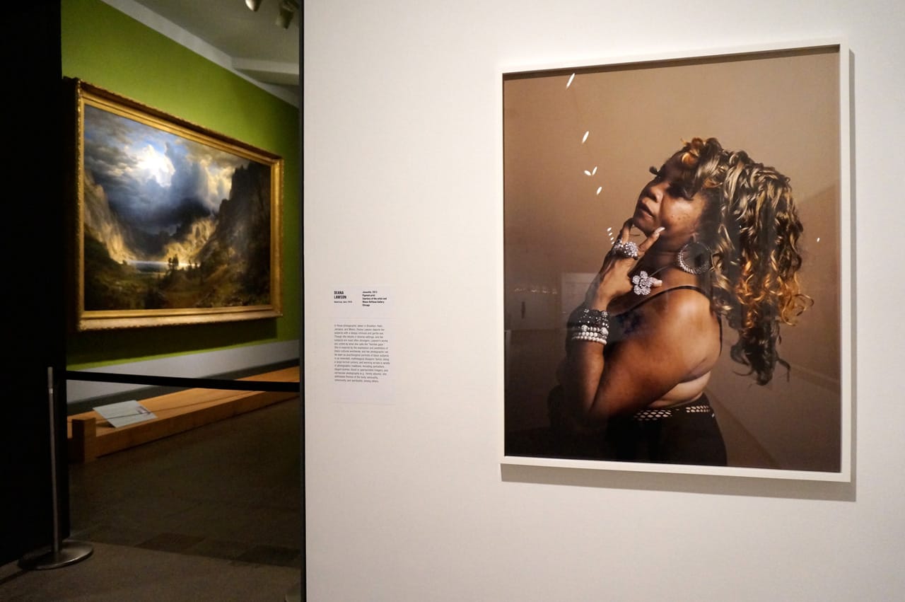Deana Lawson's "Joanette" (2013), with a painting in the museum's collection in the background at left