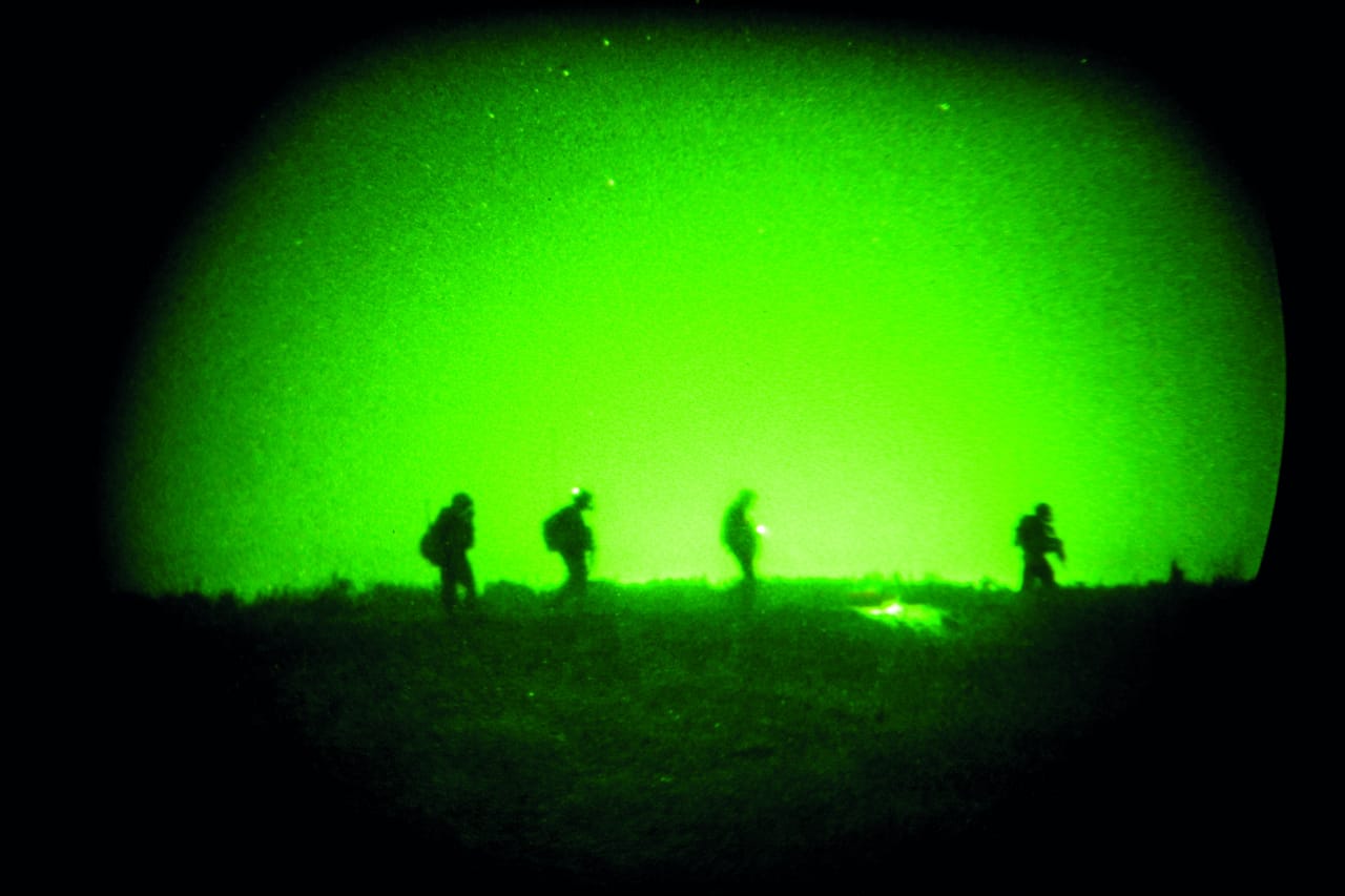 Benjamin Lowy, "Perspectives II: Nightvision" (2003-08), from "Iraq" taken with night-vision goggles US military issued ISKANDARIYA, IRAQ - JULY 15: US soldiers patrol a marsh-like field as units with the 509th Infantry Division and the 3rd Infantry's Aviation Brigade launch a joint air assault, raiding over 30 targeted areas in a large rural area near Iskanderiyah on July 15, 2007 in Iskandariya, Iraq. The raid targeted IED production and a search for suspected insurgets. The area south of Baghdad has had little US army presence in the last 6 months, and is considered a haven for Al Qaeda in Iraq. (Photo by Benjamin Lowy/Reportage by Getty Images)