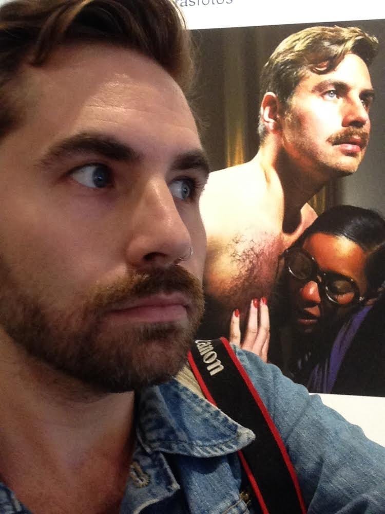 Sean Fader taking a selfie in front of his "#wishingpelt" photo in 'Richard Prince: New Portraits," Gagosian Gallery, New York