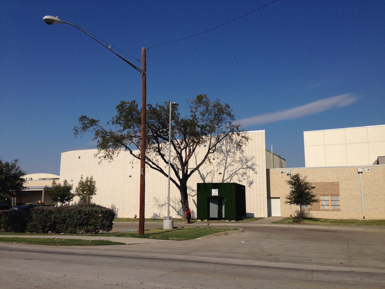 One of Lowe's three white cubes, now painted green, sits beside a middle school in Vickery Meadow. 