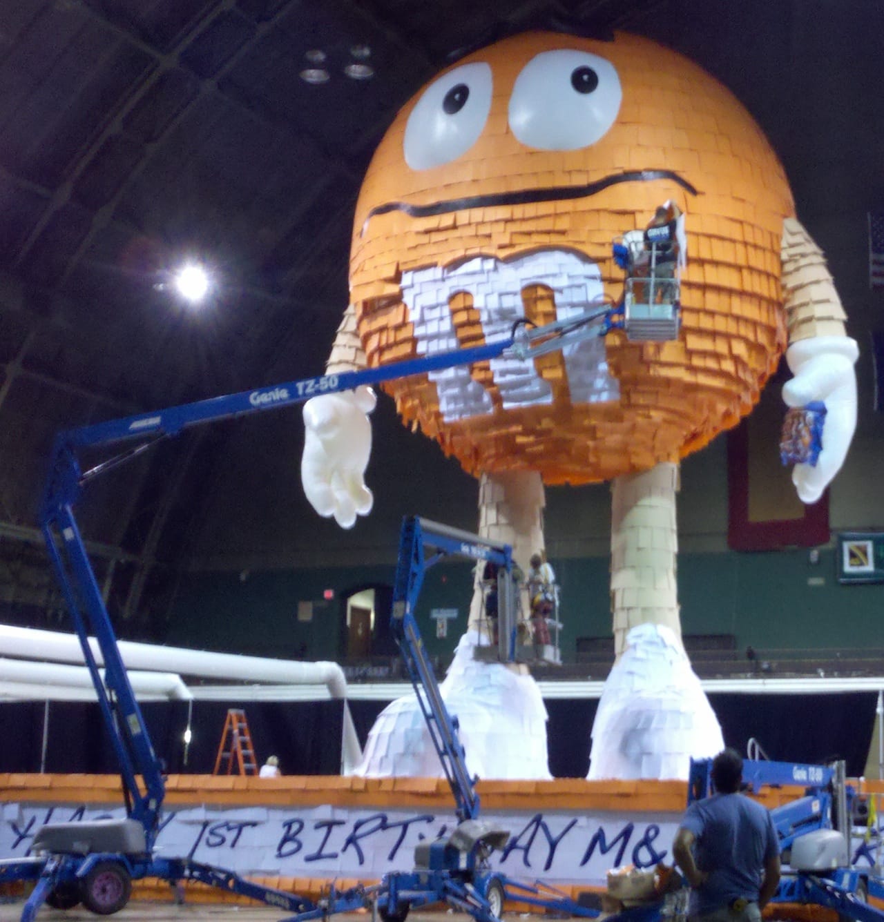 BTL's M&M Peanuts 1st Anniversary Pinata Inflatable under construction at the NYC 69th Regiment Armory holds the Guinness World Record for largest Pinata at 46ft tall. This Photo shows the BTL team at work on the yellow guy. Photo courtesy BTL.