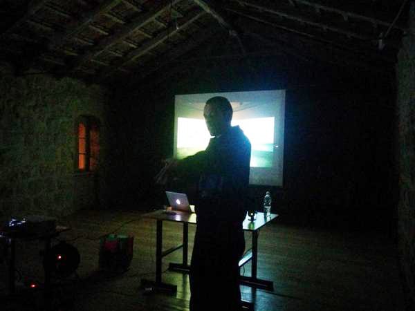 continues his presentation in a darkened room. (photo courtesy Erev Rav)
