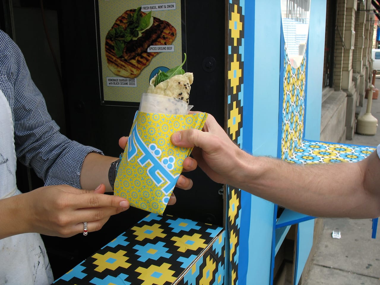 An order being handed over during the Iranian edition of Conflict Kitchen