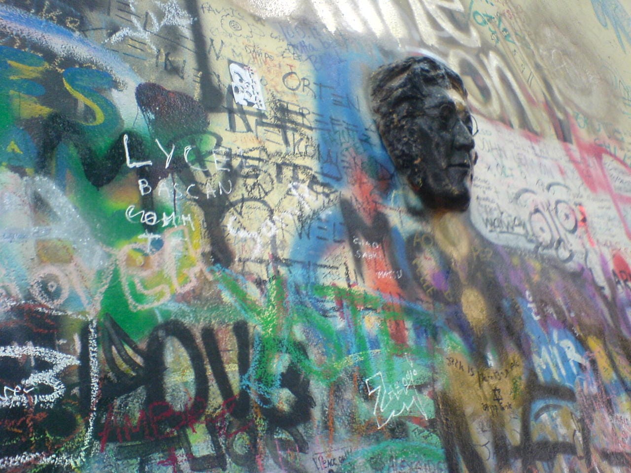 A bas relief portrait on the John Lennon Wall in 2007 (photo by brandon schauer/Flickr)