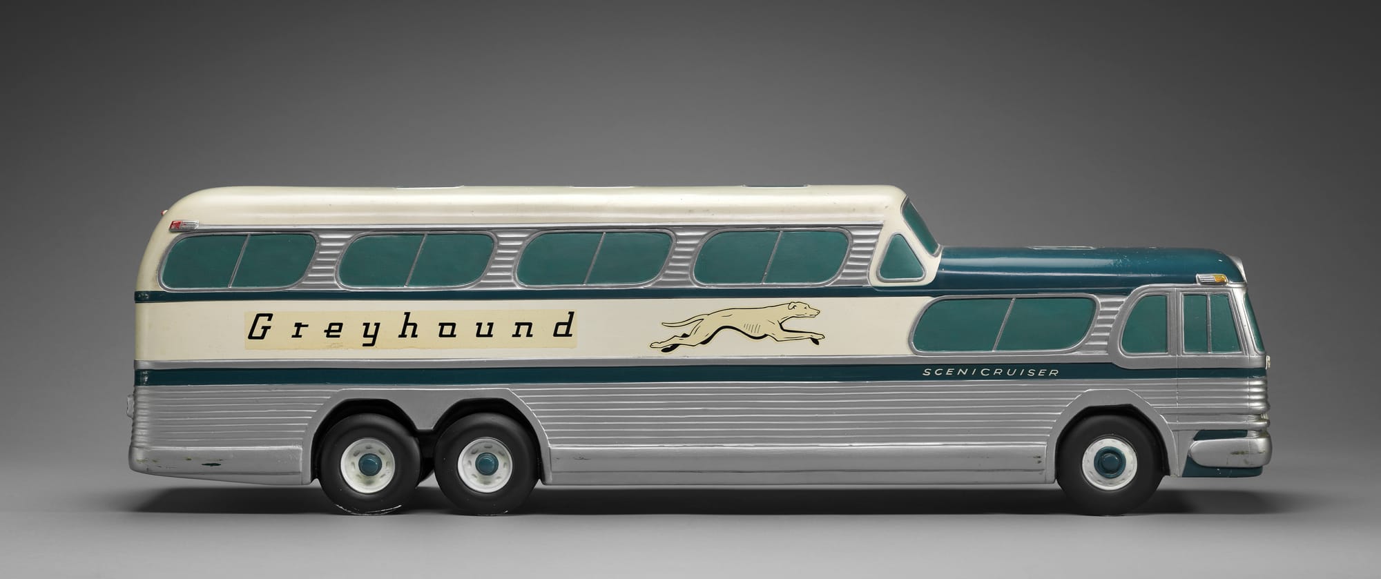 Greyhound Scenicruiser bus model, United States, Made by General Motors Corporation after original bus designed by Raymond Loewy (American, born in France, 1893–1986) (c. mid-1950s), Painted plaster, printed decals, wood, Jean S. and Frederic A. Sharf Collection, (Courtesy of the Museum of Fine Arts, Boston)