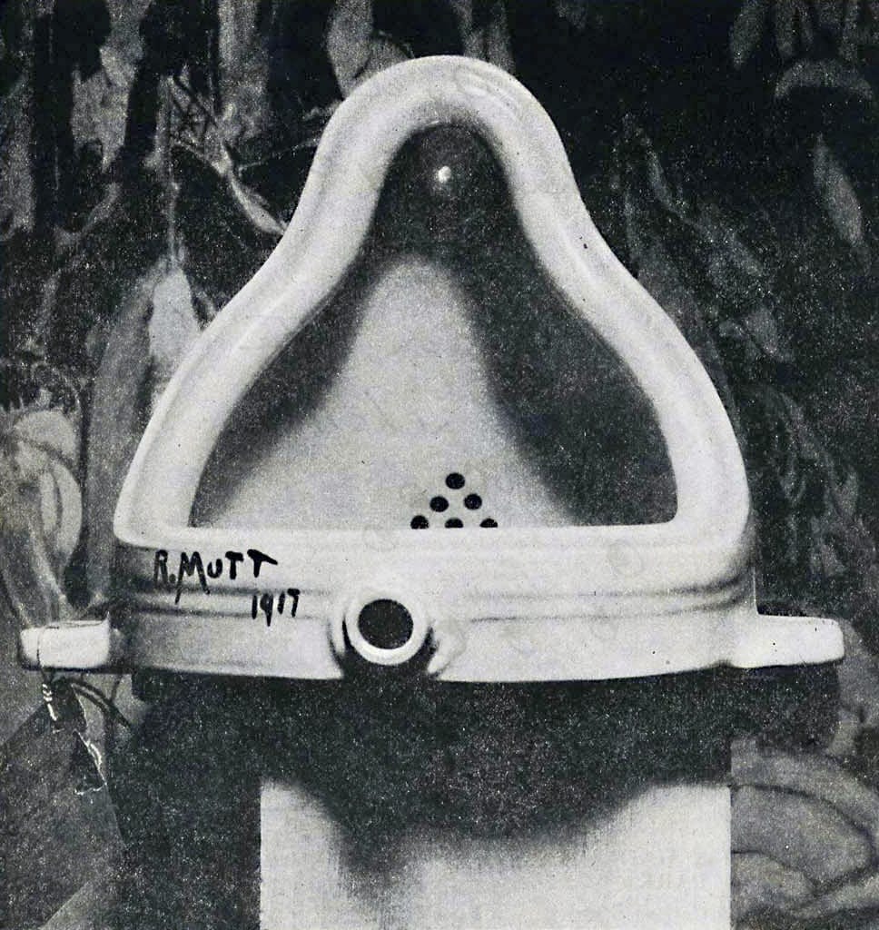 The original Fountain by Marcel Duchamp photographed by Alfred Stieglitz at the 291 (Art Gallery) after the 1917 Society of Independent Artists exhibit. Stieglitz used a backdrop of The Warriors by Marsden Hartley to photograph the urinal. The entry tag be clearly seen. (via Wikipedia)