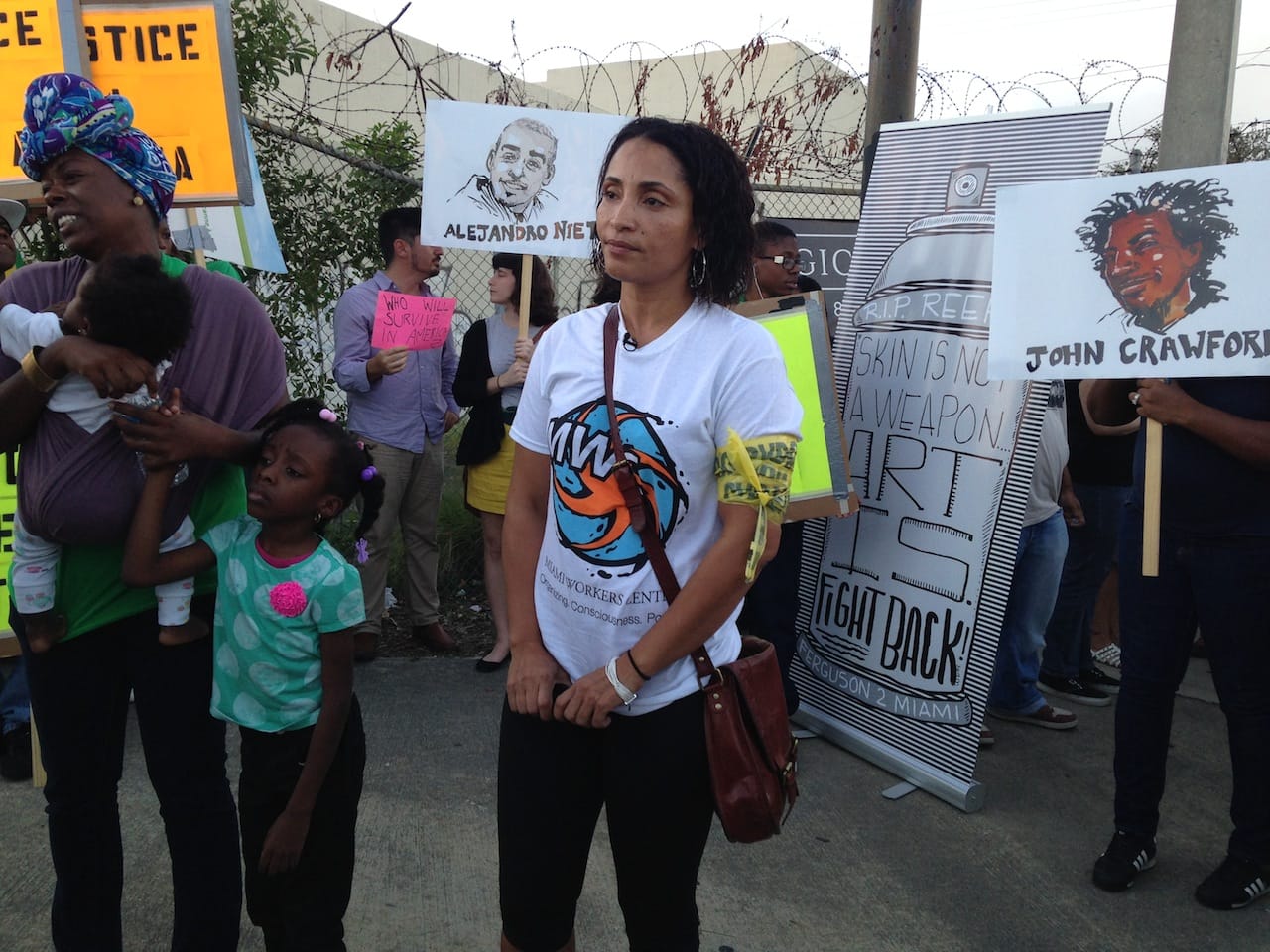 At the protest, with Ruth Noel Jean standing on the far left and protest art by Molly Crabapple and Damon Davis in the background
