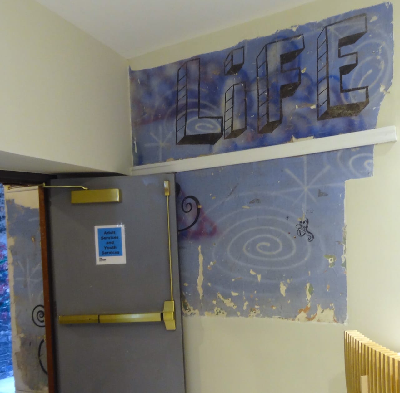 A partially concealed Kenny Scharf mural, "Love" (1989) in the LGBT Center's lobby