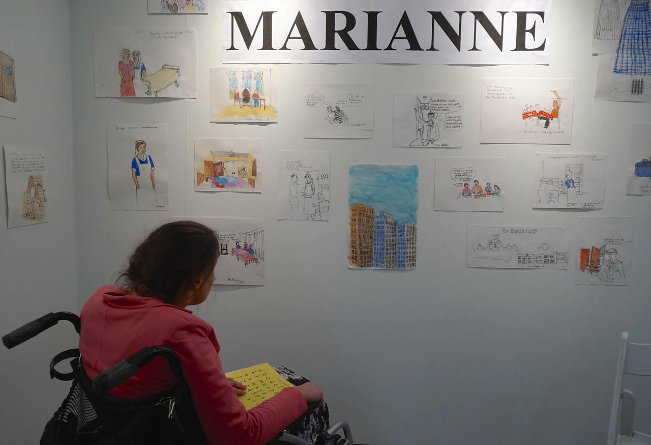 Marianne Schipaanboord with her artwork at the  Een Nieuwe Wind booth