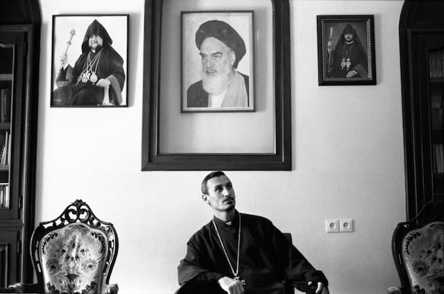 Tabriz, Iran, July 2011; Father Milorad Vaghinagh is the priest of the armenian polish. In his office he has to keep the portraits of Roullah Khomeini.