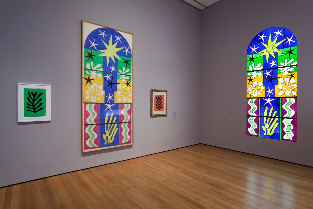 Installation view of Christmas Eve (1952), Black Leaf on Green Background (1952) and Black Leaf on Red Background (1952) in the exhibition Henri Matisse: The Cut-Outs at The Museum of Modern Art, New York (October 12, 2014-February 8, 2015). Photo by Jonathan Muzikar. © 2014 The Museum of Modern Art