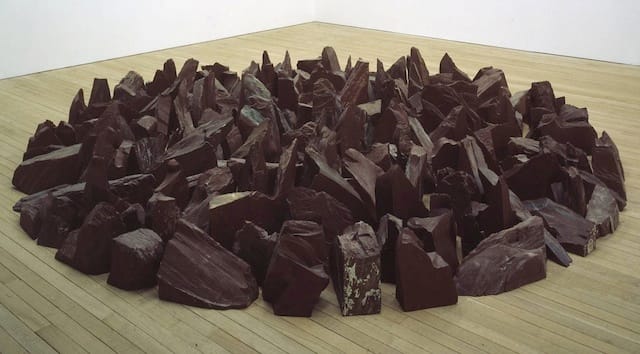Richard Long, "Red Slate Circle" (1988): "A group of people sit on the beach with two bags but also a group of people are on the beach with blankets. Reminds me of people on a beach, walking and laying on blankets."