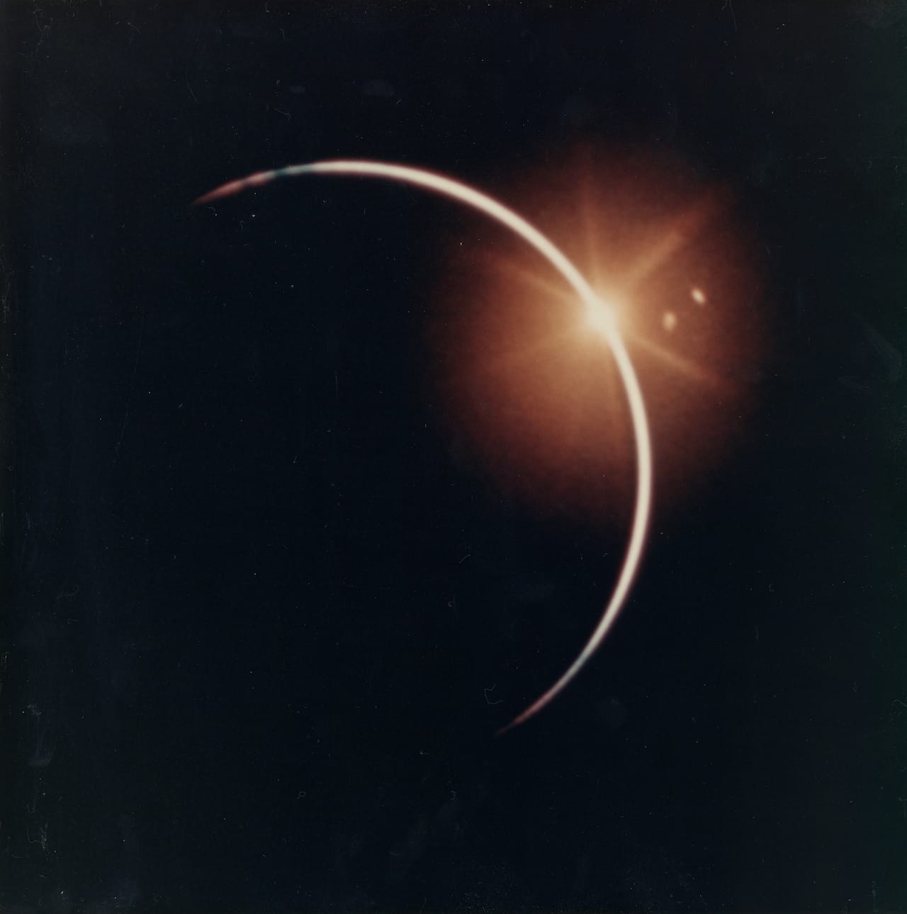 Eclipse of the Sun by the Earth, Apollo 12, November 1969 Vintage chromogenic print on resin coated Kodak paper, borderless, 20.3 x 20.3cm (8 x 8in), “A Kodak Paper” watermark on verso, [NASA S80-37406] This dramatic view of an eclipse when the Earth moved directly between the sun and the spacecraft is a scene only visible in space. It was taken with a 16mm motion-picture camera from the Apollo 12 spacecraft during its journey home from the Moon. 