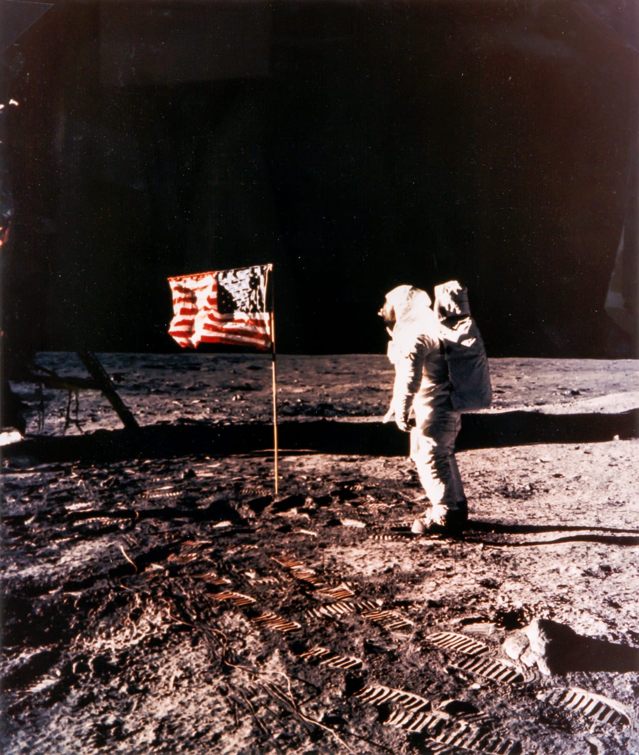 Neil Armstrong Buzz Aldrin and the American flag on the Sea of Tranquillity, Apollo 11, July 1969 Large-format vintage chromogenic print on fibre-based Kodak paper, borderless, 60 x 51cm, “A Kodak Paper” watermark on verso, NASA HQ caption on separate page, [NASA negative number AS11-40-5874] On the windless plain Aldrin saluted the American flag, stiffened with wire so it would “wave”. Illustrated: Moon p.194-195 Est. £5,000-7,000 Reproduction, © Bloomsbury Auctions