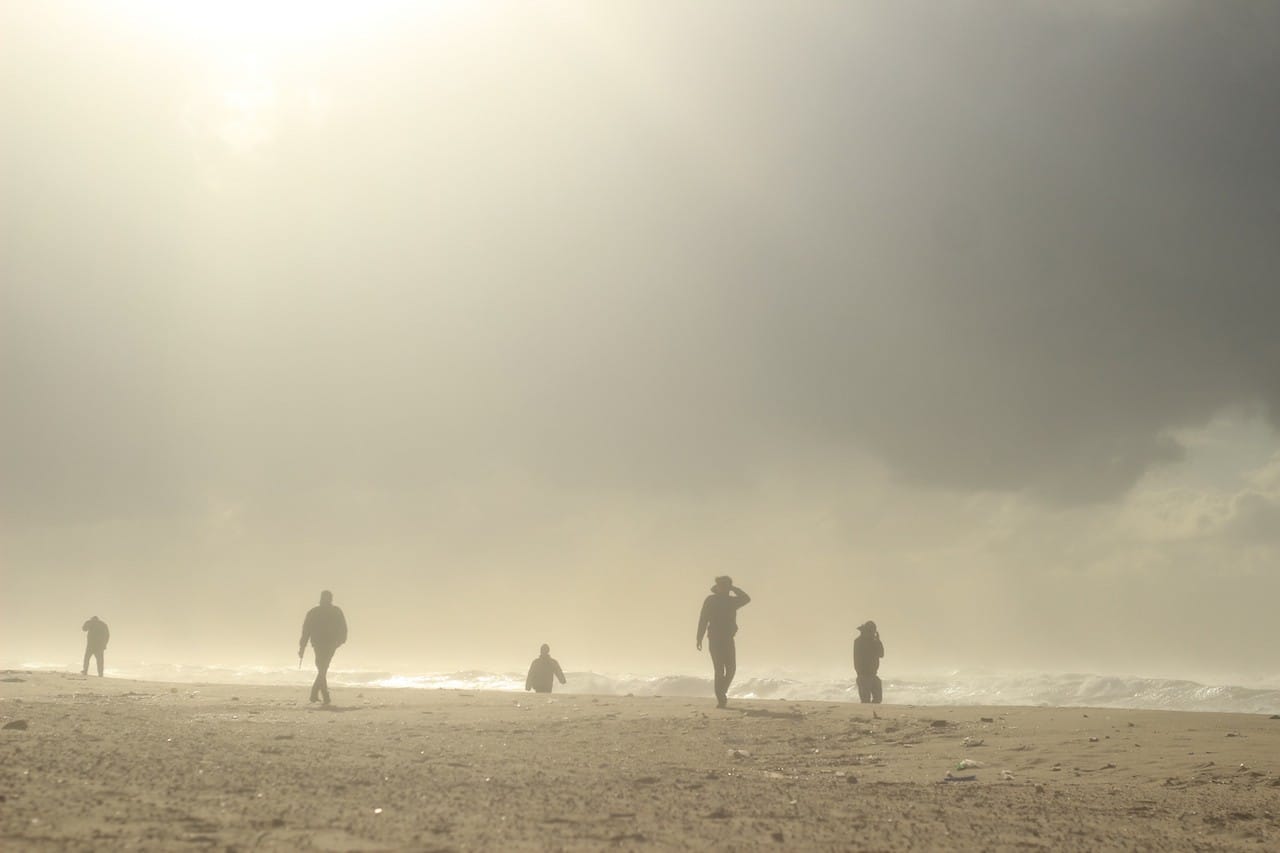Fishermen walk along the Northern shore of Gaza beach during a stormy day, Gaza Strip, Palestine. December 11, 2014. © Basel Alyazouri.