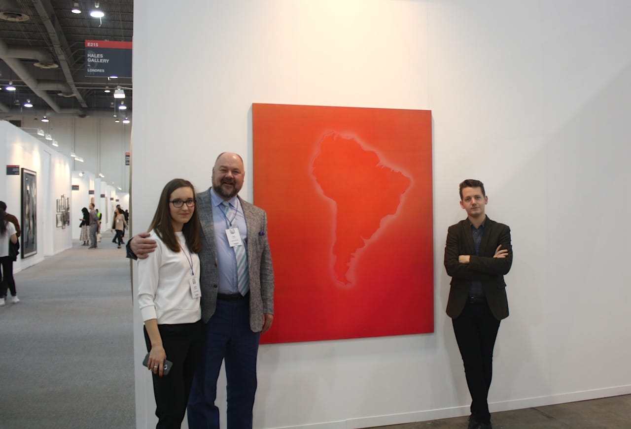 Hales Gallery staff with painting by Frank Bowling