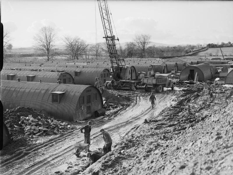 Quonset Huts being assembled at the Londonderry Naval Base (circa 1942–45) (photo by Royal Navy official photographer, Lieutenant Tomlin H W, courtesy the Imperial War Museum, via Wikimedia Commons)