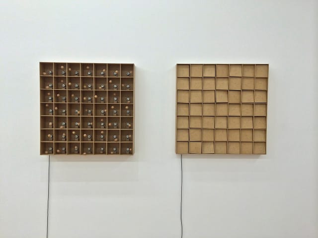 Zimoun, Left: "49 prepared dc-motors, cork balls, mdf boxes 13x13x13cm" (2015),  Right: "49 prepared dc-motors, mdf elements, mdf boxes 13x13x13cm" (2015