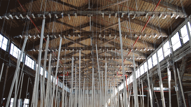 Zimoun, "250 prepared ac-motors, 325 kg roof laths, 1.8 km rope" (2015), motors, wood, steel hooks, nylon fiber, power transformer (gif by author for Hyperallergic)