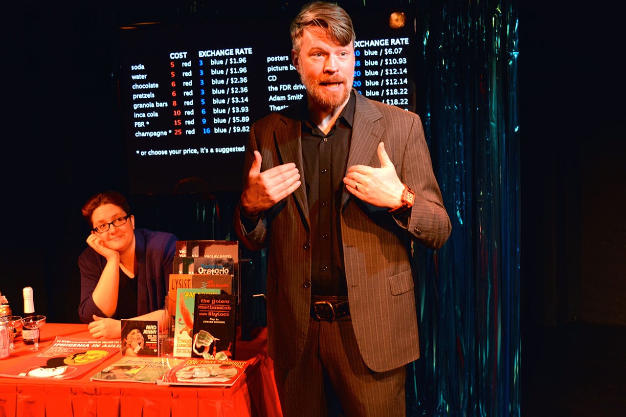Emcee Mick O’Brien (right) works the concession table with Corinne Woods (left) in 'Money Lab.' (all photos by Arthur Cornelius, courtesy HERE Arts Center)